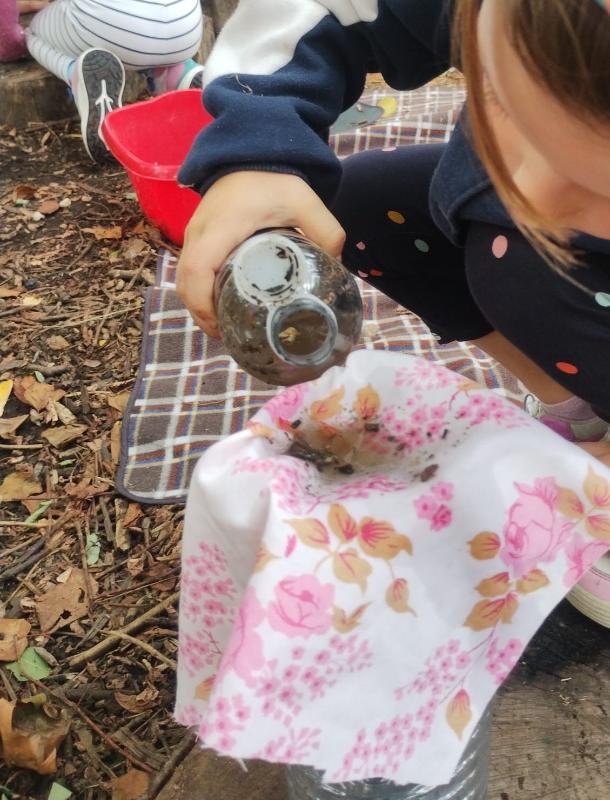 A child exploring water and fabric