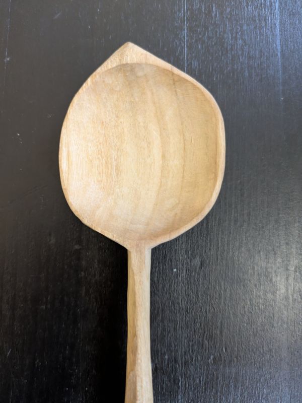 A leaf shaped wooden serving spoon
